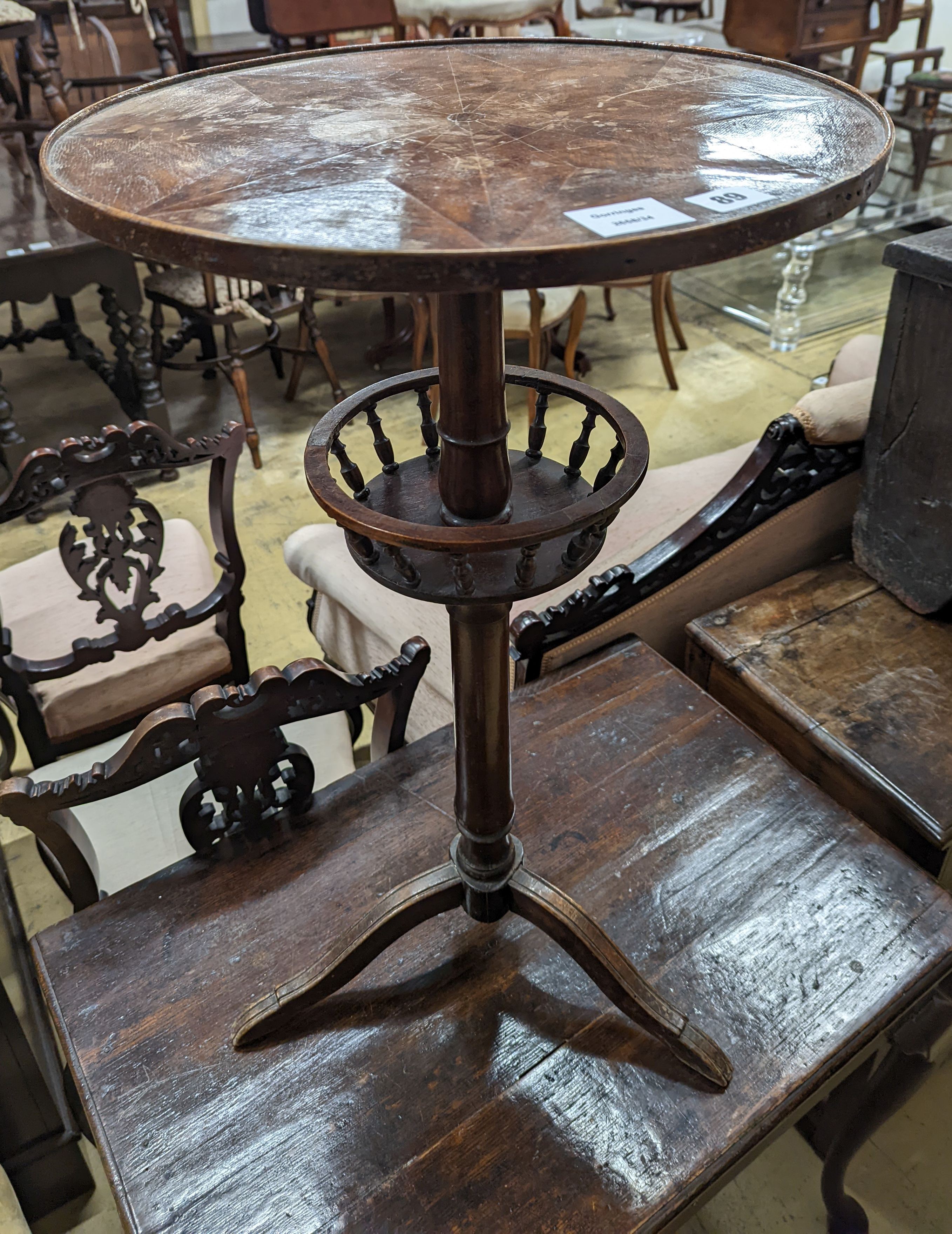 An early 19th century primitive circular tripod table, diameter 42cm, height 73cm